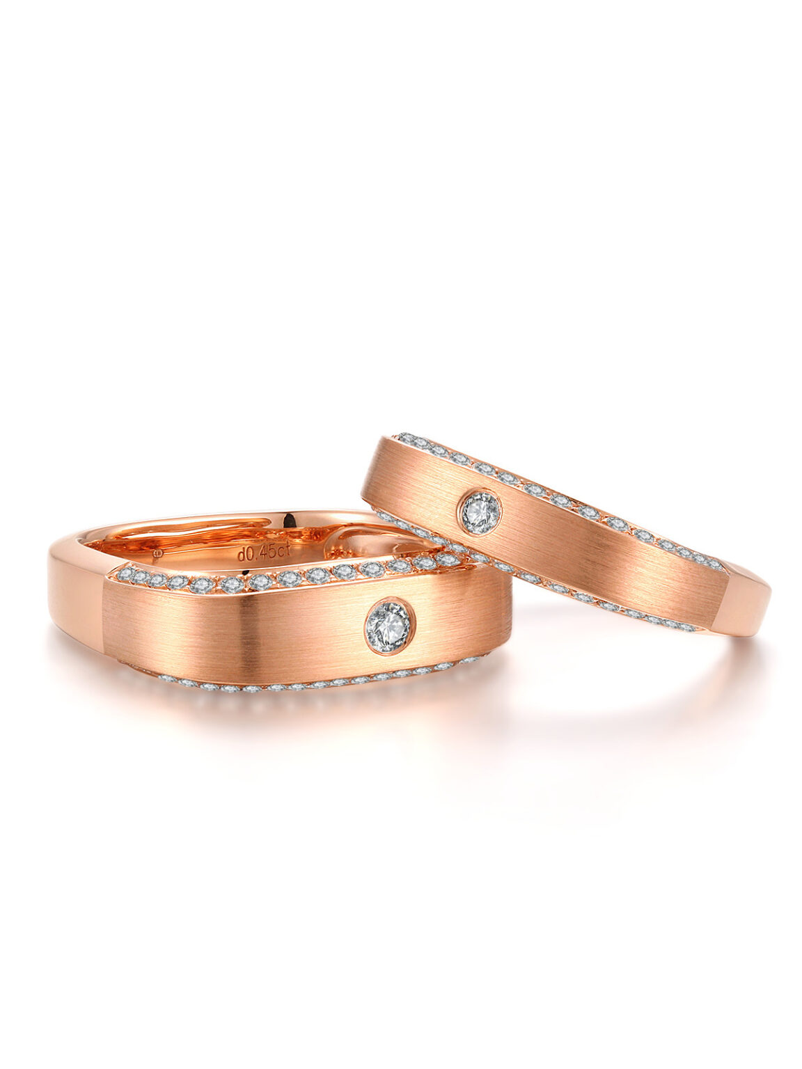 Matching his and hers rose gold flat band ring set with single center cubic zirconia, blank white background wedding couple jewelry product photography, minimalist promise ring high resolution studio sample for bridal jewelry store